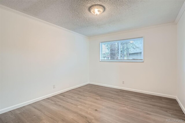 5300 E Cherry Creek S Drive 217, Denver, CO 80246 - spare room with wood finished floors, a textured ceiling, ornamental molding, and baseboards