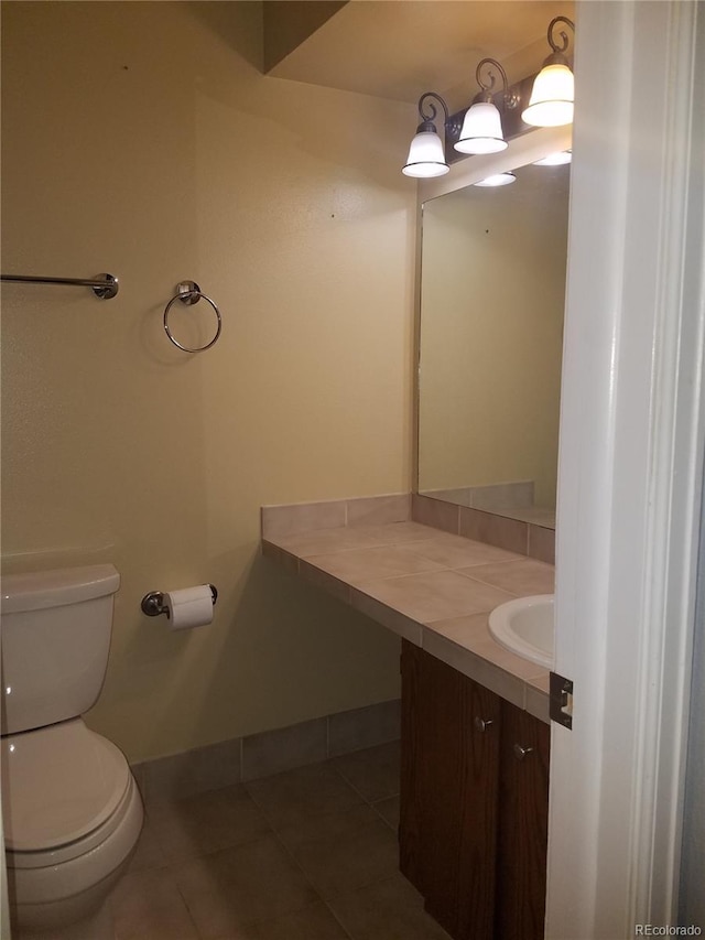 bathroom featuring vanity, tile patterned flooring, and toilet