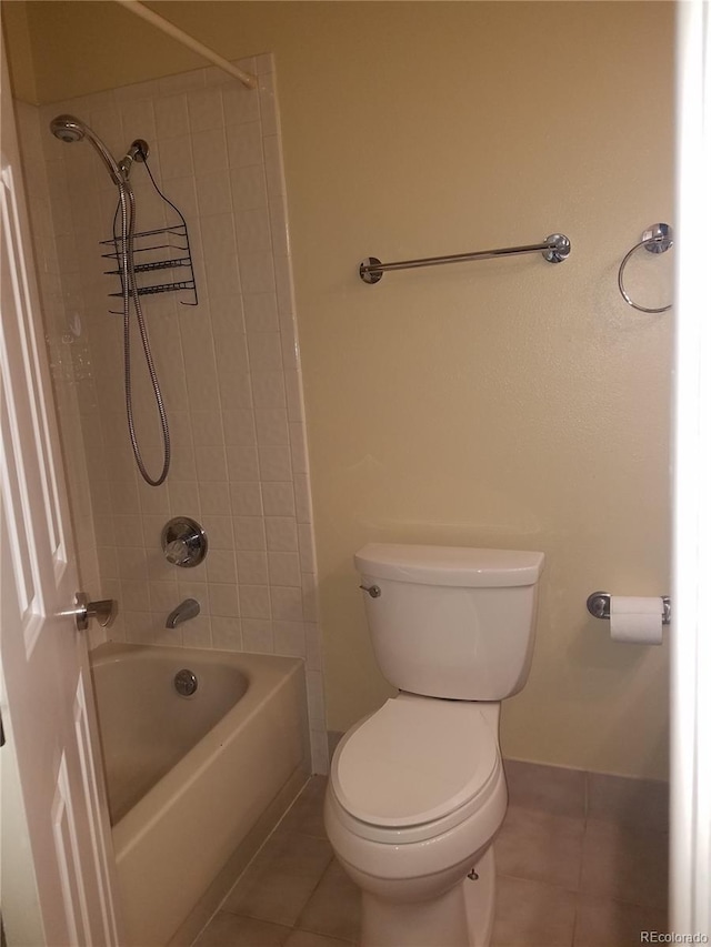 bathroom featuring toilet, tile patterned flooring, and baseboards