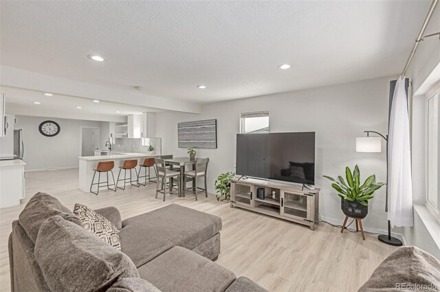 7752 Meade St, Westminster, CO 80030 - living room with recessed lighting, baseboards, and light wood finished floors