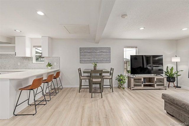 7752 Meade St, Westminster, CO 80030 - dining area featuring light wood-type flooring, beamed ceiling, recessed lighting, and baseboards