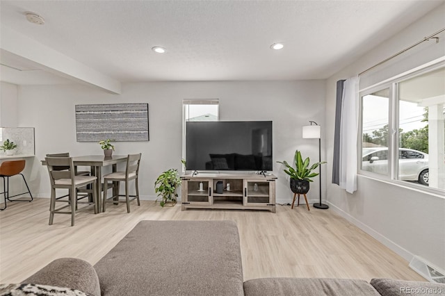 7752 Meade St, Westminster, CO 80030 - living room with wood finished floors, baseboards, and recessed lighting