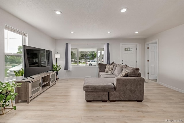 7752 Meade St, Westminster, CO 80030 - living area with baseboards, light wood-type flooring, recessed lighting, and a textured ceiling