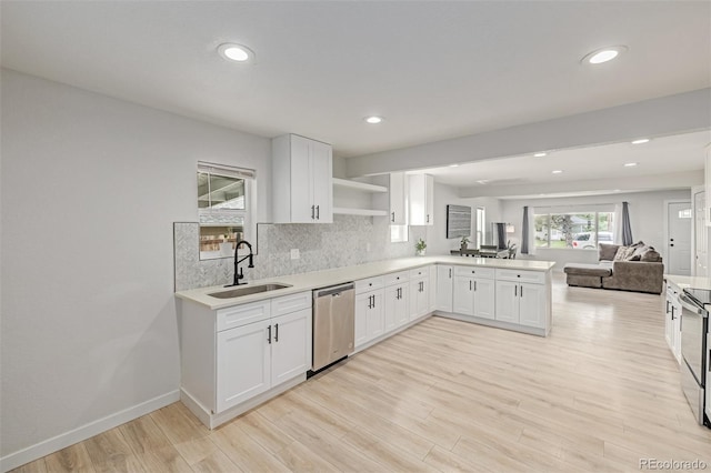 7752 Meade St, Westminster, CO 80030 - kitchen with a sink, stainless steel dishwasher, open floor plan, open shelves, and a peninsula