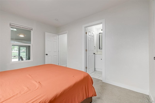 7752 Meade St, Westminster, CO 80030 - bedroom with baseboards, light carpet, and connected bathroom