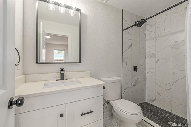7752 Meade St, Westminster, CO 80030 - bathroom with vanity, toilet, and a marble finish shower