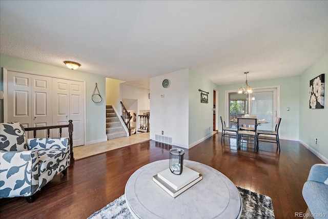 8364 Allison Ct, Arvada, CO 80005 - living room featuring hardwood / wood-style flooring, stairway, baseboards, and a chandelier