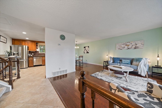 8364 Allison Ct, Arvada, CO 80005 - living room featuring baseboards, recessed lighting, a chandelier, and a textured ceiling