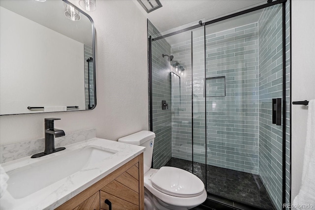 8364 Allison Ct, Arvada, CO 80005 - bathroom with a shower stall, toilet, a textured wall, and vanity