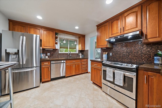 8364 Allison Ct, Arvada, CO 80005 - kitchen with stainless steel appliances, under cabinet range hood, a sink, brown cabinetry, and recessed lighting