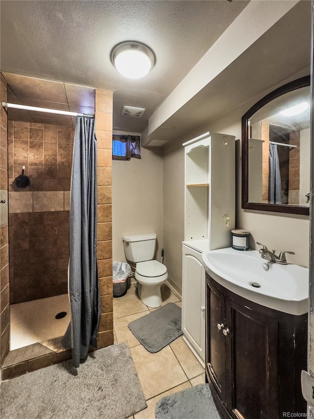2114 N 21st St, Grand Junction, CO 81501 - bathroom with vanity, tile patterned floors, a tile shower, and a textured ceiling