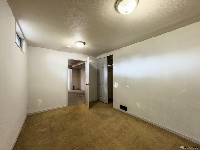 2114 N 21st St, Grand Junction, CO 81501 - unfurnished bedroom featuring a textured ceiling, carpet flooring, and a closet