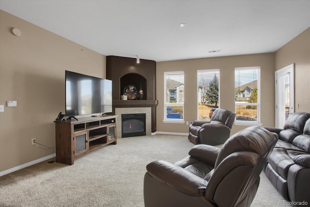 living room with light colored carpet and a fireplace