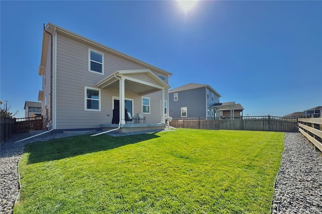 back of house with a yard and a patio area