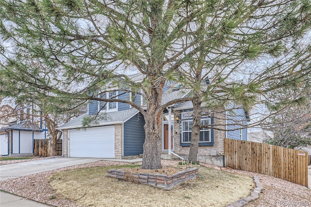 view of front of house featuring brick siding, an attached garage, fence, and driveway