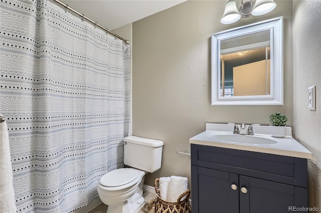bathroom with toilet and vanity