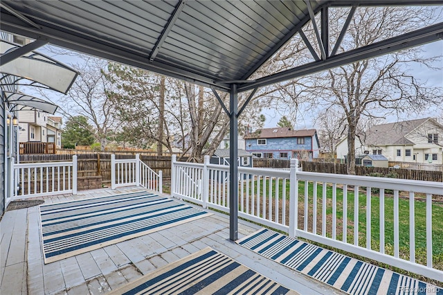 deck featuring a yard, a residential view, and a fenced backyard