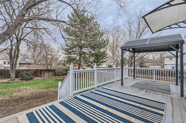 deck with a yard and fence