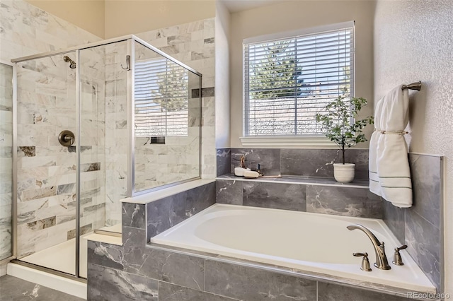 bathroom with a garden tub and a shower stall