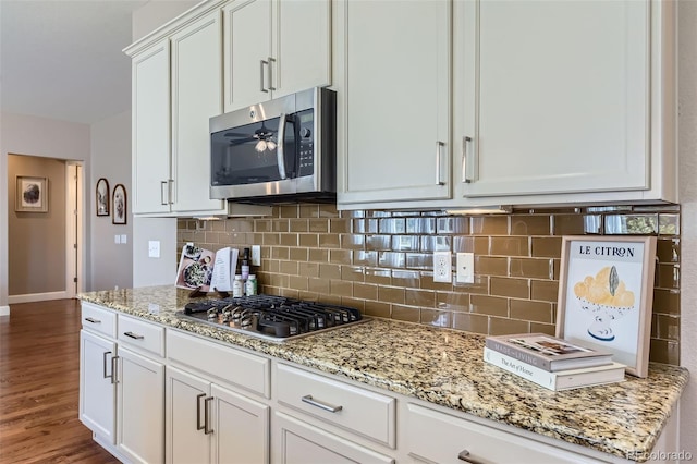 kitchen featuring light stone countertops, white cabinetry, and stainless steel appliances