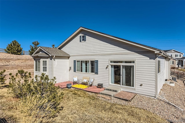 rear view of property with a patio and a lawn