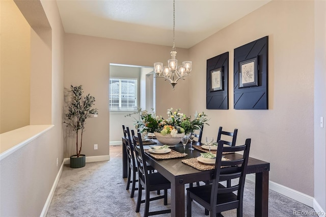 dining space with carpet floors, an inviting chandelier, and baseboards