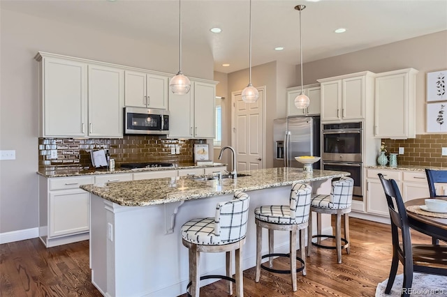 kitchen featuring white cabinetry, dark wood-style flooring, stainless steel appliances, and a sink