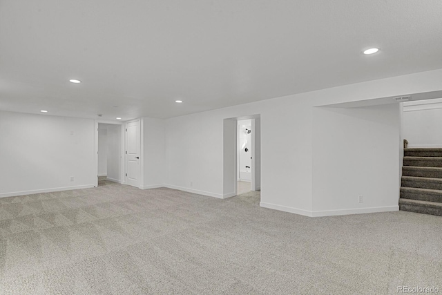 basement featuring light colored carpet