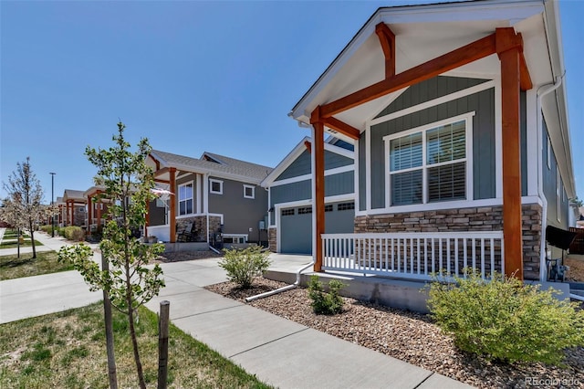 11494 Colony Loop, Parker, CO 80138 - view of front facade with board and batten siding, a porch, driveway, and stone siding