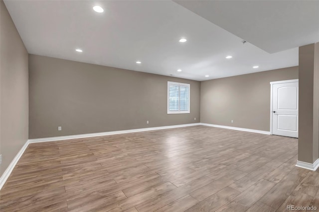 unfurnished room featuring baseboards, recessed lighting, and light wood finished floors