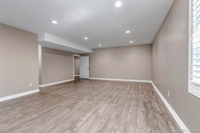 below grade area featuring recessed lighting, light wood-style floors, and baseboards