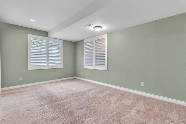 empty room with baseboards and carpet flooring