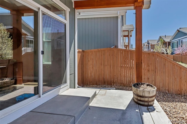 view of patio / terrace featuring fence and a residential view