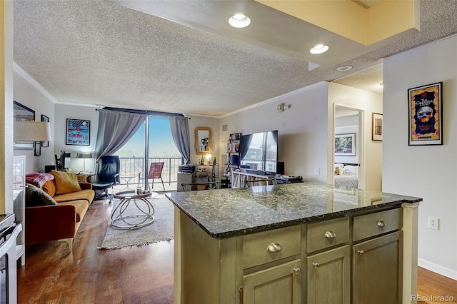 kitchen featuring dark stone counters, crown molding, a textured ceiling, and dark hardwood / wood-style flooring