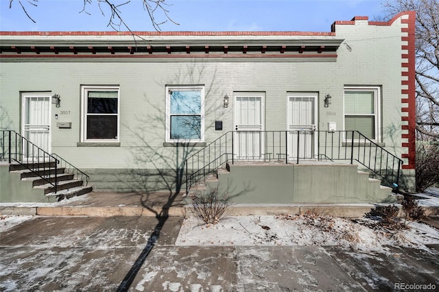 view of property featuring brick siding