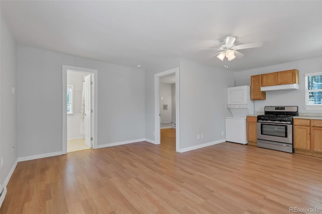 kitchen with fridge, light hardwood / wood-style floors, stainless steel range with gas stovetop, and ceiling fan