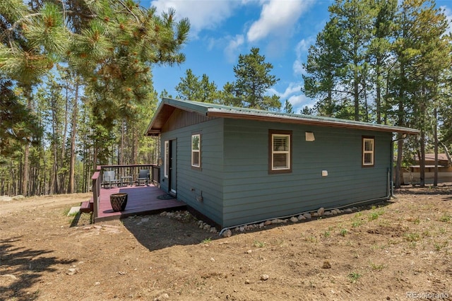 view of side of home with a wooden deck