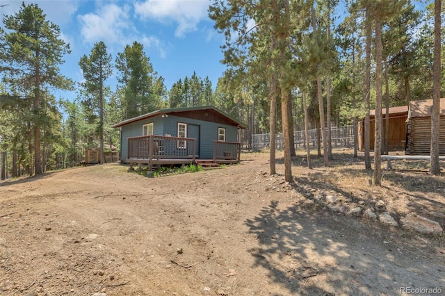 view of side of home with a wooden deck