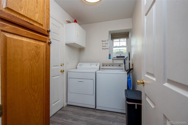 washroom with cabinets, dark hardwood / wood-style floors, and separate washer and dryer