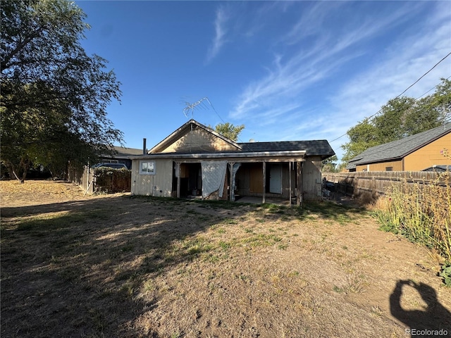 back of property featuring a lawn