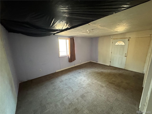 foyer entrance with dark colored carpet