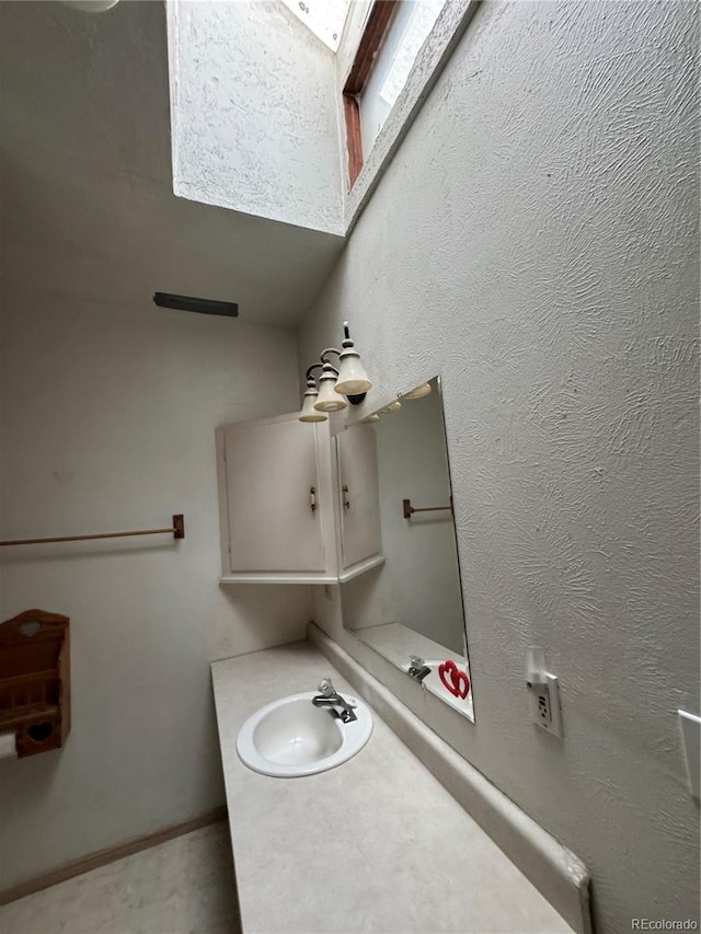 bathroom featuring vanity and a skylight