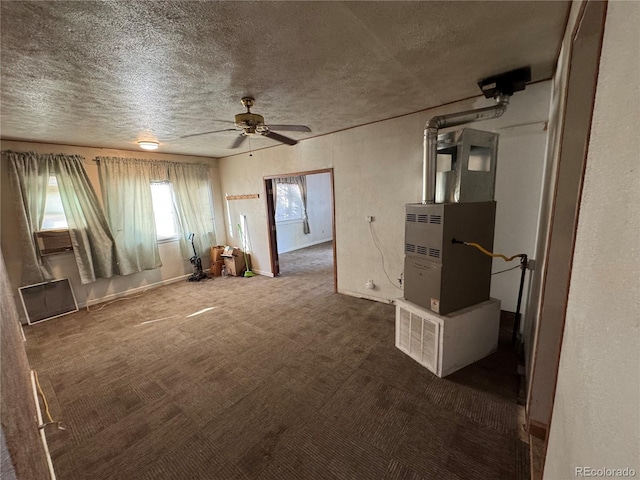 carpeted spare room with a textured ceiling, heating unit, and ceiling fan