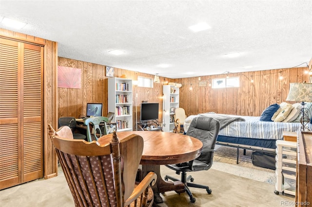 office space featuring wooden walls and a textured ceiling