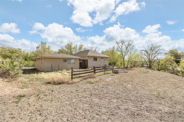 rear view of house with fence