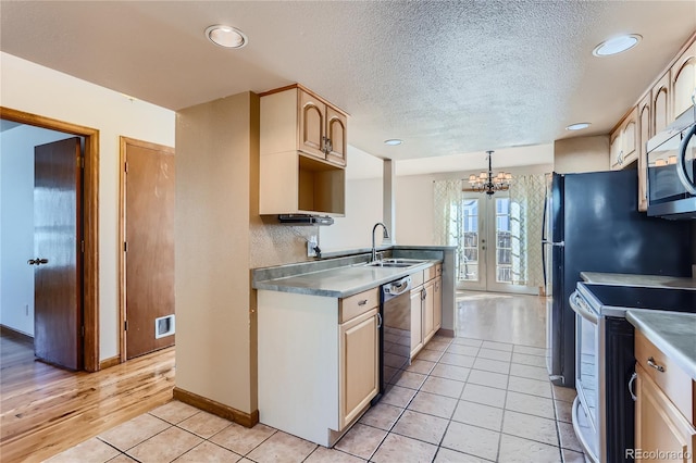 kitchen featuring pendant lighting, sink, black dishwasher, light tile patterned floors, and electric stove