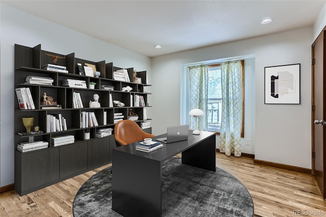 home office with recessed lighting, light wood-style flooring, and baseboards