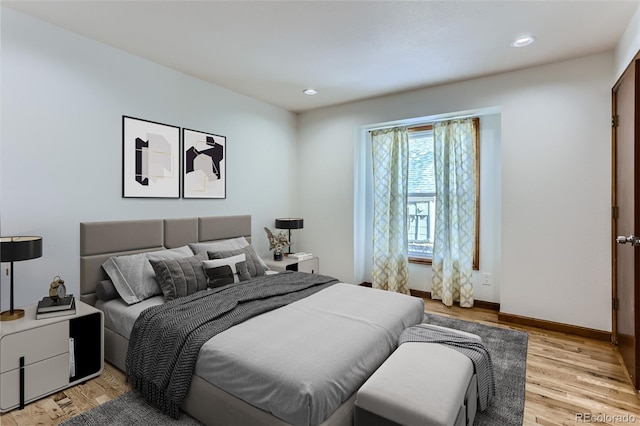 bedroom with light wood-style flooring, baseboards, and recessed lighting