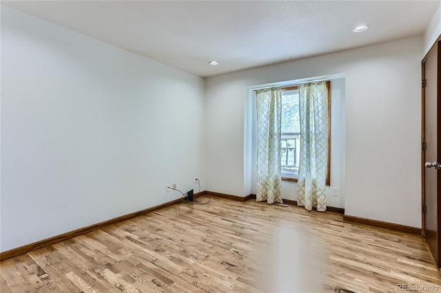 unfurnished room featuring recessed lighting, light wood-style flooring, and baseboards