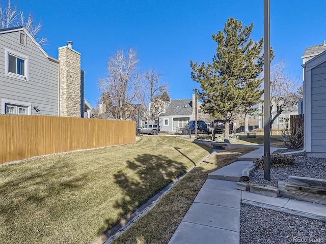 view of yard featuring fence and a residential view